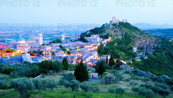 View over Assisi in the early morning, blue hour, with the Rocca Maggiore castle on a hill next to