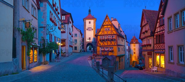 Town view of Rothenburg ob der Tauber in the evening at blue hour, in the foreground the Plönlein