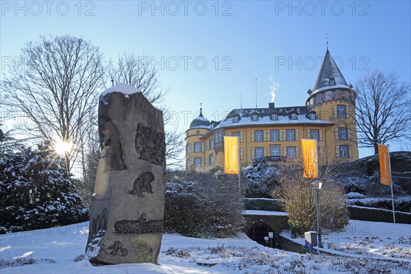 Genoveva Castle built 13th century backlit in winter with sculpture stone holder, stonemason,