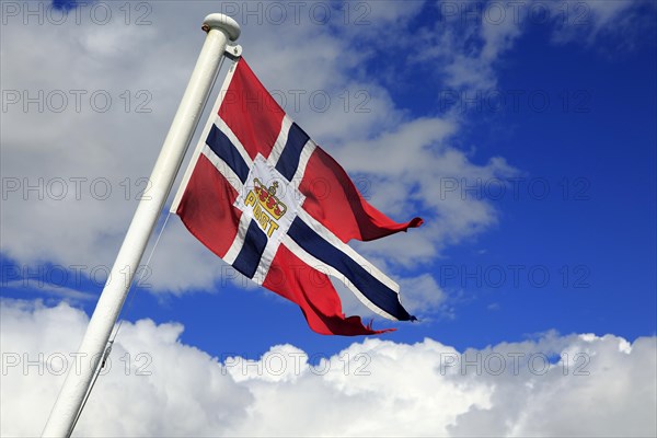 National flag flying on post ship Hurtigruten ferry, Norway, Europe