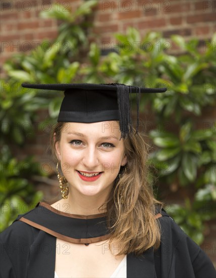 Head and shoulders portrait smiling young woman graduating, Goldsmiths, University of London,