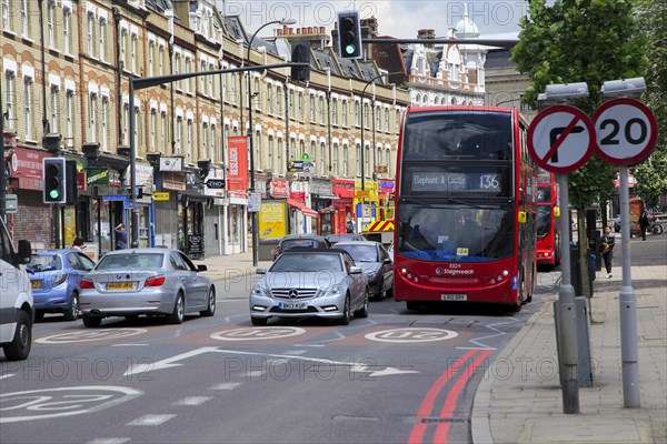 Red double-decker Stagecoach 136 bus in New Cross Road, Deptford, south London, England, UK