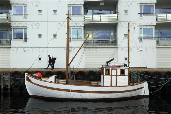 Traditional wooden boat outside modern housing apartments, Molde, Romsdal county, Norway, Europe