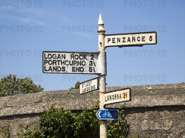 Old road sign distances and directions, St Buryan, Cornwall, England, UK