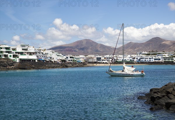 Yacht arriving in harbour at Playa Blanca, Lanzarote, Canary Islands, Spain, Europe