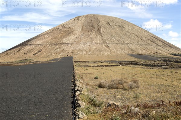 Volcano cone and black volcanic soil farmland, near Tinajo, Lanzarote, Canary Islands, Spain,
