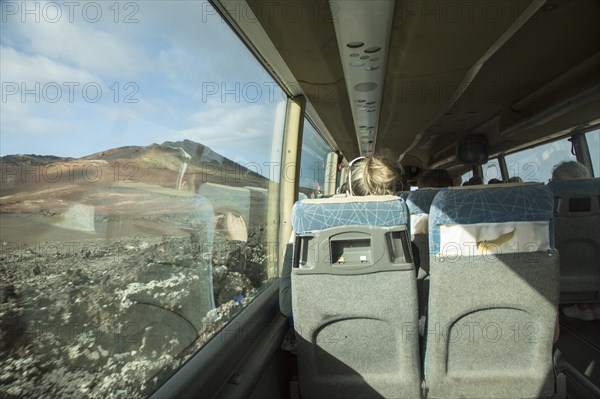 Tourists on tour bus on Ruta de Los Volcanes, Parque Nacional de Timanfaya, national park,