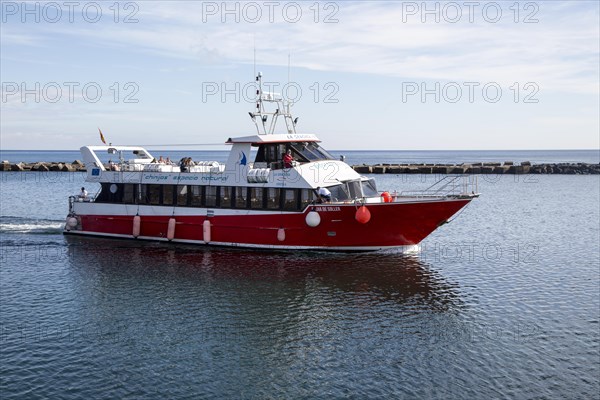 Tourist ferry boat arriving in Orzola harbour from La Graciosa, Lanzarote, Canary Islands, Spain,