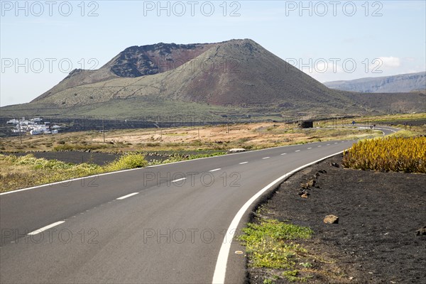 Road leading to cone of Mount Corona volcano and Ye village, Haria, Lanzarote, Canary Islands,