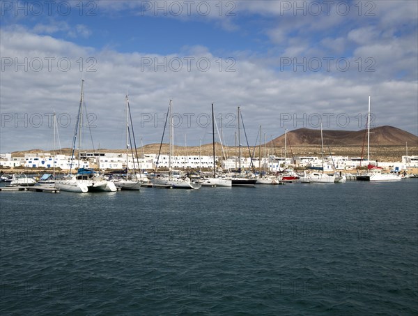 Yachts at moorings Caleta de Sebo harbour and village, La Isla Graciosa, Lanzarote, Canary Islands,