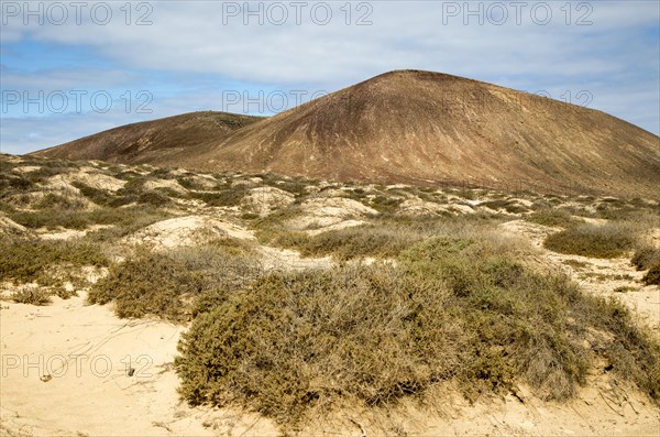 Inland sand dune landscape view towards Agujas Chicas volcano, La Isla Graciosa, Lanzarote, Canary