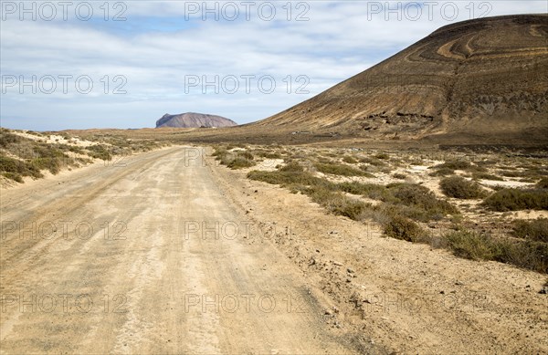 Unmade road passing Agujas Grandes volcano, La Isla Graciosa, Lanzarote, Canary Islands, Spain,