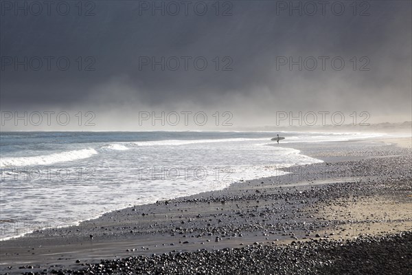 Atlantic Ocean coast beach and waves with morning sea mist, Caleta de Famara, Lanzarote, Canary