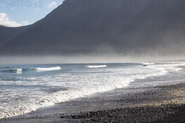 Atlantic Ocean coast beach and waves with morning sea mist, Caleta de Famara, Lanzarote, Canary