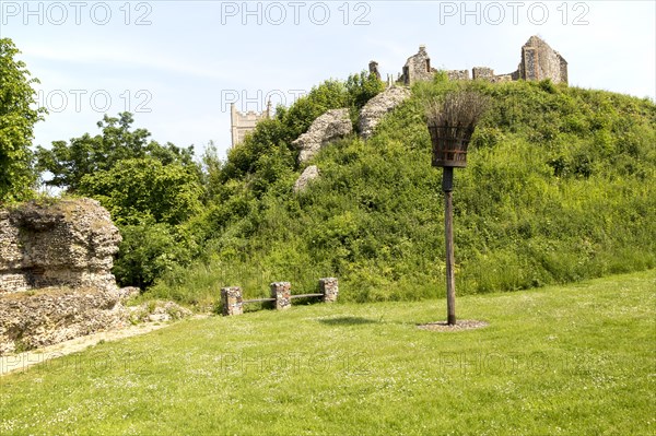 Norman motte and bailey castle with Victorian building ruin Eye, Suffolk, England, UK