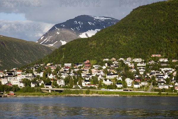 Suburban housing and landscape of snow on mountain side, Tromso, Norway, Europe