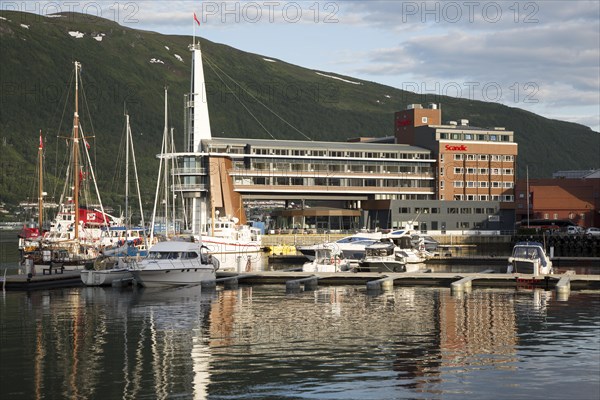 Modern architecture of Scandic Hotel and boats in harbour, city centre of Tromso, Norway, Europe