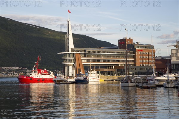 Modern architecture of Scandic Hotel and boats in harbour, city centre of Tromso, Norway, Europe