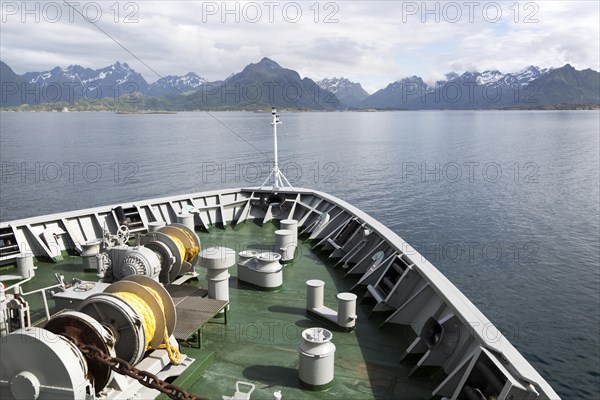Hurtigruten ferry ship approaching the southern coast of Hinnoya Island, Nordland, northern Norway