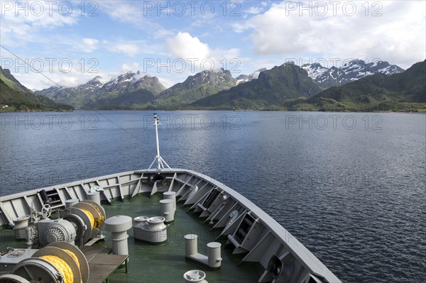 Hurtigruten ferry ship approaching the southern coast of Hinnoya Island, Nordland, northern Norway