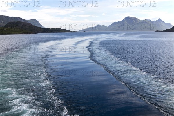 Wake of Hurtigruten ferry ship in water of Raftsundet strait of Hinnoya Island, Nordland, northern