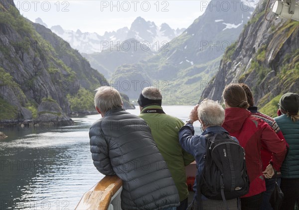 Tourists sightseeing from Hurtugruten ship, Trollfjorden, Lofoten Islands, Nordland, northern,