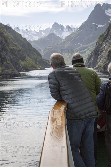 Tourists sightseeing from Hurtugruten ship, Trollfjorden, Lofoten Islands, Nordland, northern,