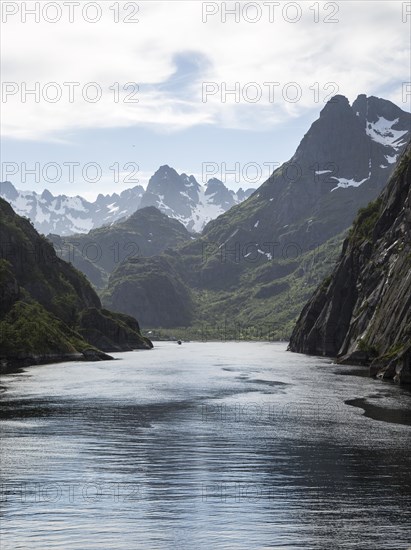 Steep sided glacial trough fiord jagged mountain peaks, Trollfjorden, Lofoten Islands, Nordland,