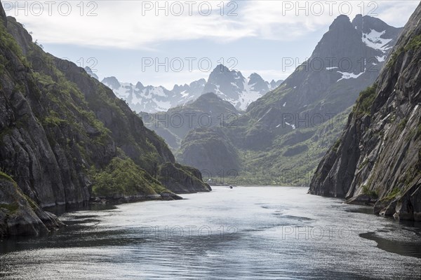 Steep sided glacial trough fiord jagged mountain peaks, Trollfjorden, Lofoten Islands, Nordland,