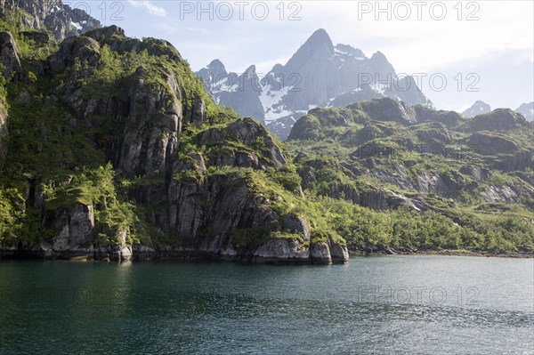 Steep sided glacial trough fiord jagged mountain peaks, Trollfjorden, Lofoten Islands, Nordland,