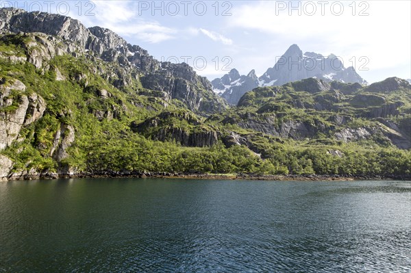 Steep sided glacial trough fiord jagged mountain peaks, Trollfjorden, Lofoten Islands, Nordland,