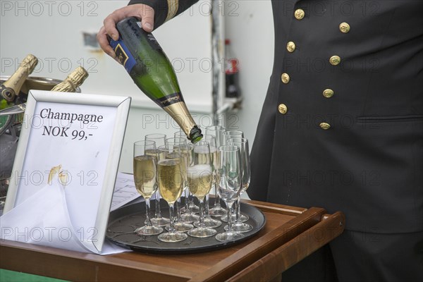 Champagne celebration crossing the Arctic Circle heading south, Norway on Hurtigruten ferry ship,