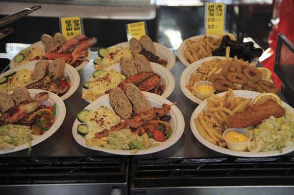 Sample street stall restaurant display fish meals in Torget market, Bergen, Norway, Europe