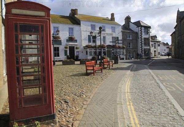 Traditional red telephone kiosk box in village square, Marazion Cornwall, England, UK