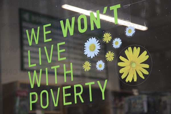 Anti-poverty message in Oxfam shop window, Oxford, England, UK