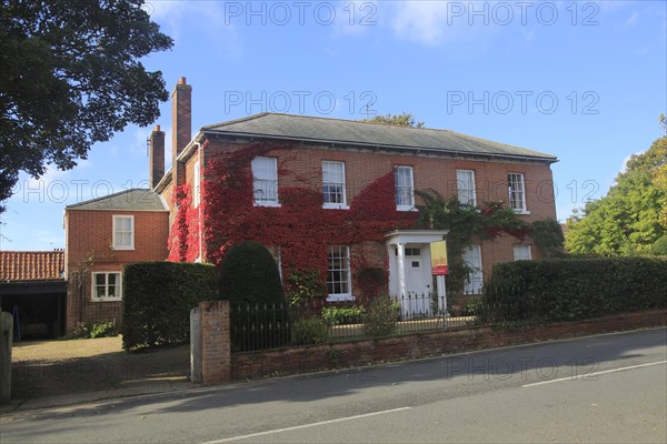 Savills estate agent sign outside large detached house, Orford, Suffolk, England, UK