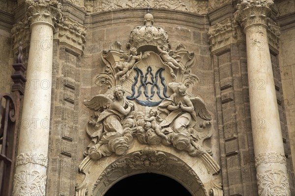 Ornately carved decorated stonework above the entrance to the cathedral church in city of Valencia,