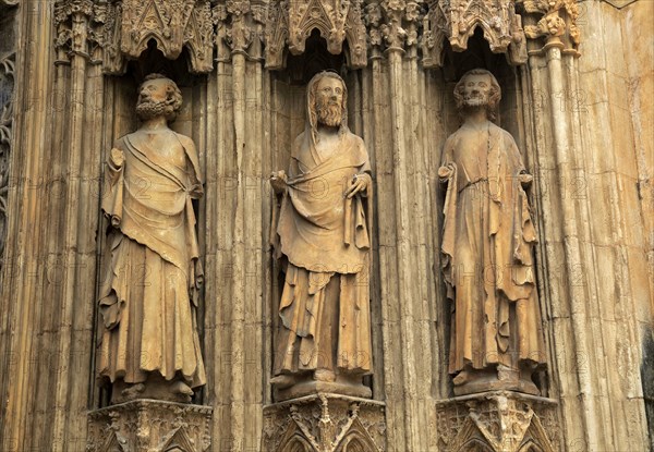 Statues of Christian saints carved stonework of the cathedral church in city of Valencia, Spain,