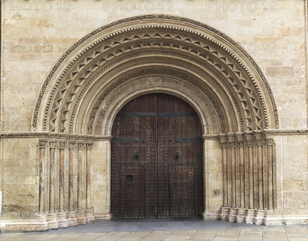 Arched doorway of the cathedral church building in city of Valencia, Spain, Europe