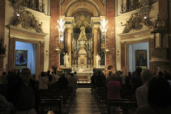 Catholic mass priest at altar in cathedral church, city of Valencia, Spain, Europe