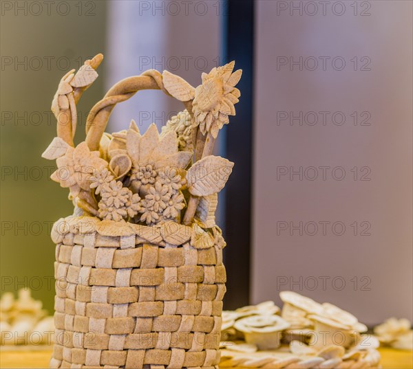 Intricate bread basket adorned with detailed flowers and leaves