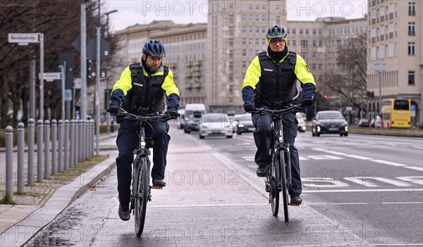 Employees of the bicycle squadron of the public order office with their bikes on a street. The