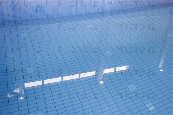 Lamps reflected in the swimming pool of the reopened Tiergarten municipal swimming pool, Berlin,