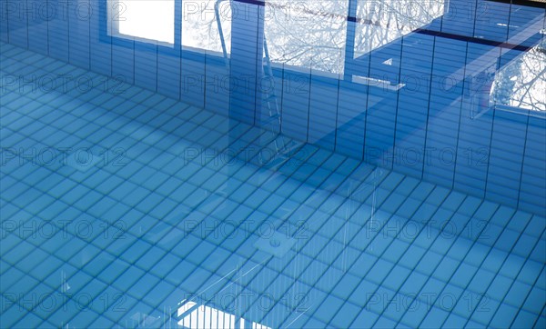 The diving tower is reflected in the swimming pool of the reopened Tiergarten municipal swimming