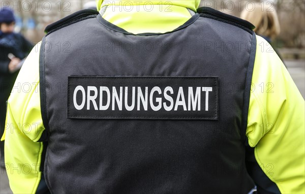 An employee of the bicycle squadron of the public order office wears a protective waistcoat,