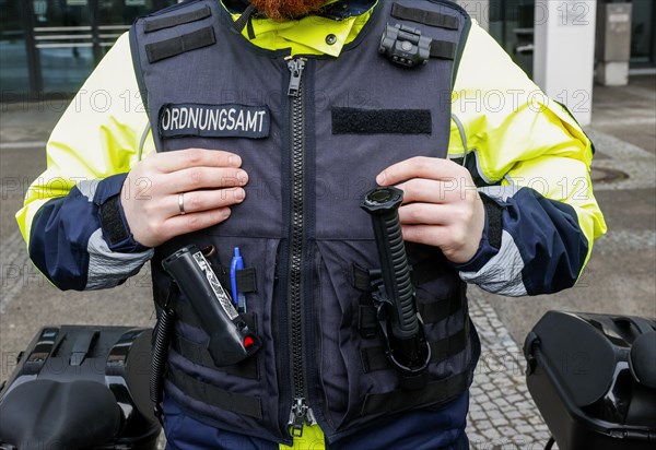 An employee of the bicycle squadron of the public order office wears a protective waistcoat,