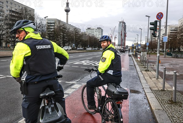 Employees of the bicycle squadron of the public order office with their bikes on a street. The