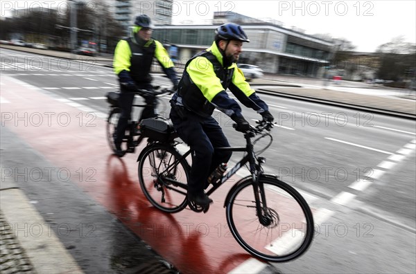 Employees of the bicycle squadron of the public order office with their bikes on a street. The