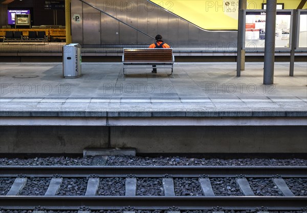 A passenger sits on a bench at Südkreuz station. The fourth train drivers' strike by the German