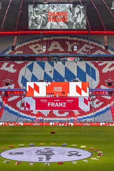 Banner with Franz Beckenbauer and wreaths of flowers, behind the speaker's stage at the end of the